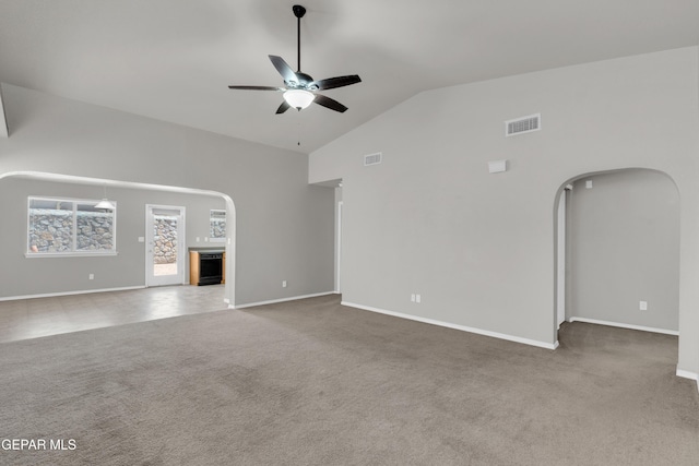 7029 Copper Canyon Dr, El Paso, TX 79934 - unfurnished living room with arched walkways, carpet floors, a ceiling fan, and high vaulted ceiling