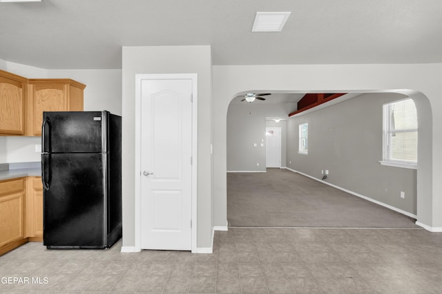 7029 Copper Canyon Dr, El Paso, TX 79934 - kitchen featuring freestanding refrigerator, arched walkways, ceiling fan, and light countertops
