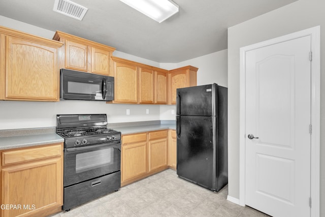 7029 Copper Canyon Dr, El Paso, TX 79934 - kitchen with black appliances, light brown cabinets, light countertops, and light flooring