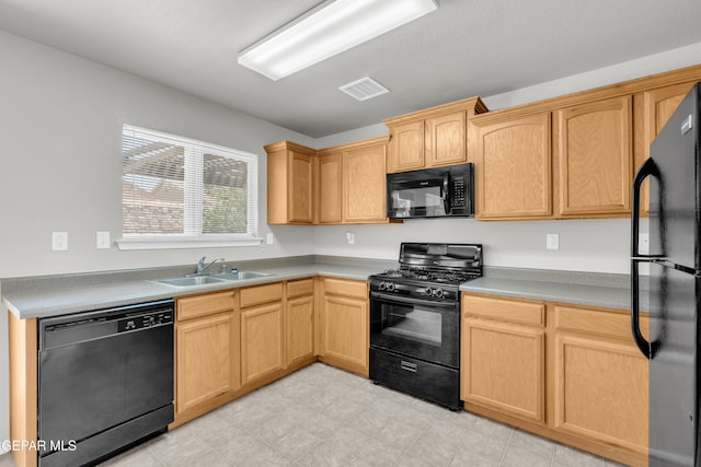 7029 Copper Canyon Dr, El Paso, TX 79934 - kitchen with black appliances, light brown cabinets, and light countertops