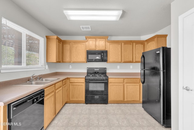 7029 Copper Canyon Dr, El Paso, TX 79934 - kitchen with black appliances, light brown cabinets, and light countertops