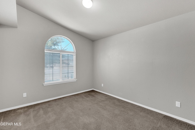 7029 Copper Canyon Dr, El Paso, TX 79934 - spare room with dark colored carpet and lofted ceiling