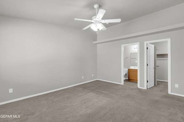 7029 Copper Canyon Dr, El Paso, TX 79934 - unfurnished bedroom with a walk in closet, carpet, ensuite bath, a closet, and a ceiling fan