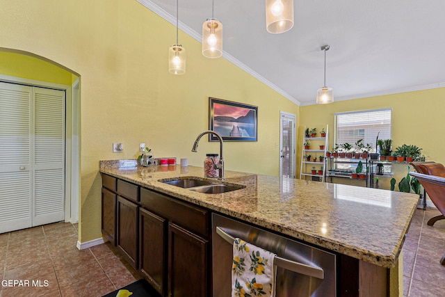 11652 Ochre Bluff Ln, El Paso, TX 79934 - kitchen with stainless steel dishwasher, lofted ceiling, ornamental molding, dark tile patterned floors, and a peninsula
