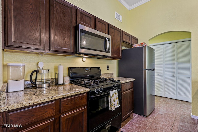 11652 Ochre Bluff Ln, El Paso, TX 79934 - kitchen featuring stainless steel appliances, crown molding, dark brown cabinetry, tile patterned floors, and light stone countertops