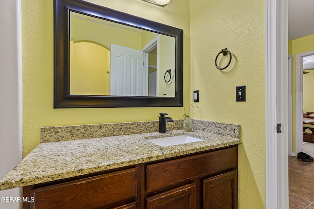 11652 Ochre Bluff Ln, El Paso, TX 79934 - bathroom featuring vanity, tile patterned flooring, and a textured wall