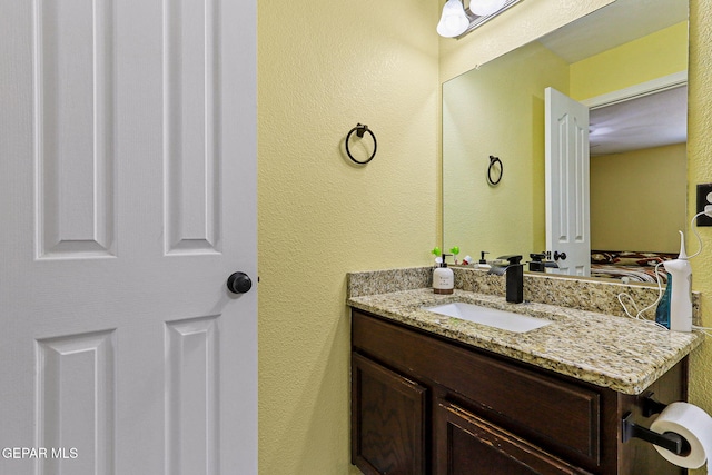 11652 Ochre Bluff Ln, El Paso, TX 79934 - bathroom featuring vanity and a textured wall