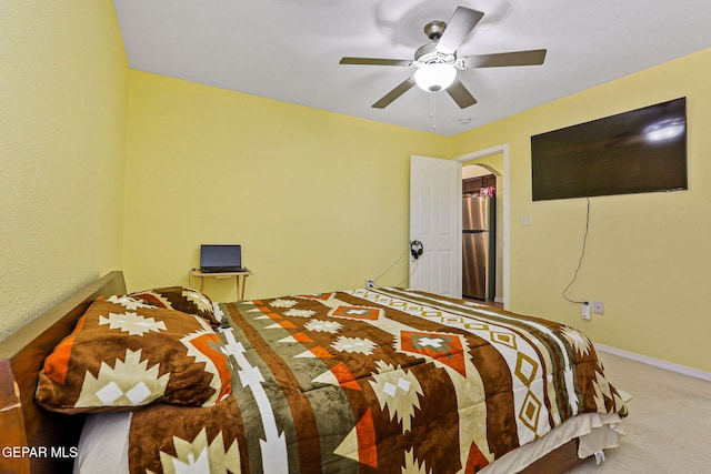 11652 Ochre Bluff Ln, El Paso, TX 79934 - carpeted bedroom with freestanding refrigerator, arched walkways, and a ceiling fan