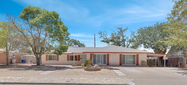 3313 Dublin Rd, El Paso, TX 79925 - single story home with brick siding, concrete driveway, and an attached carport