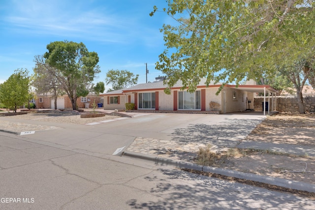 3313 Dublin Rd, El Paso, TX 79925 - single story home with concrete driveway, brick siding, and an attached carport