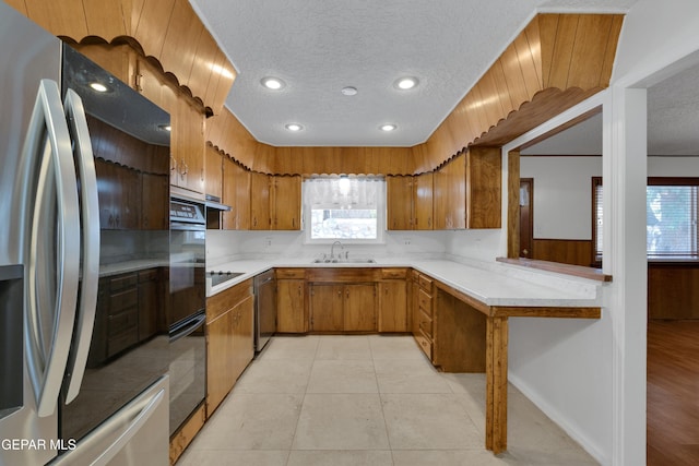 3313 Dublin Rd, El Paso, TX 79925 - kitchen with black appliances, brown cabinetry, light countertops, plenty of natural light, and recessed lighting