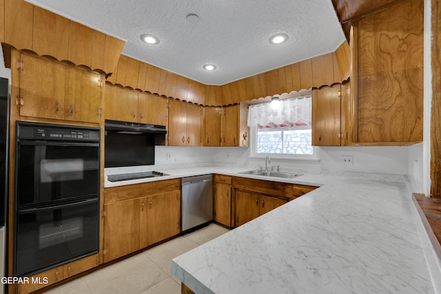 3313 Dublin Rd, El Paso, TX 79925 - kitchen with black appliances, under cabinet range hood, brown cabinetry, light countertops, and a textured ceiling