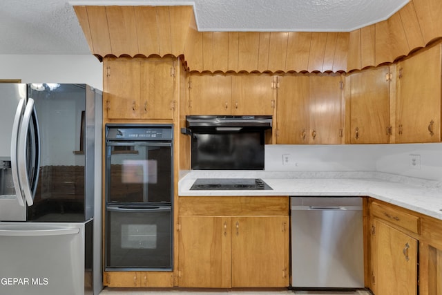 3313 Dublin Rd, El Paso, TX 79925 - kitchen with black appliances, a textured ceiling, under cabinet range hood, light countertops, and brown cabinetry