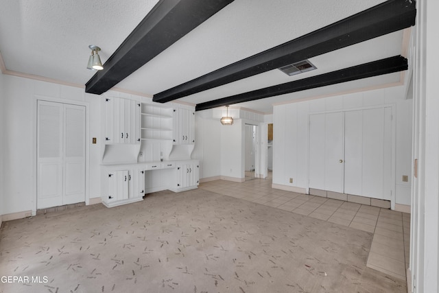 3313 Dublin Rd, El Paso, TX 79925 - unfurnished living room featuring beam ceiling, light tile patterned floors, and a textured ceiling