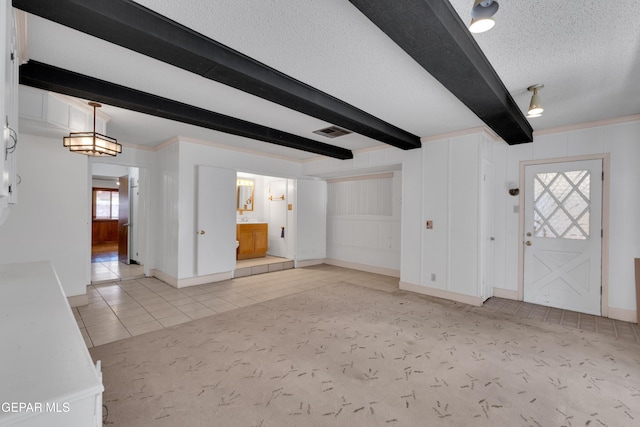 3313 Dublin Rd, El Paso, TX 79925 - unfurnished living room featuring beam ceiling, a textured ceiling, and tile patterned floors