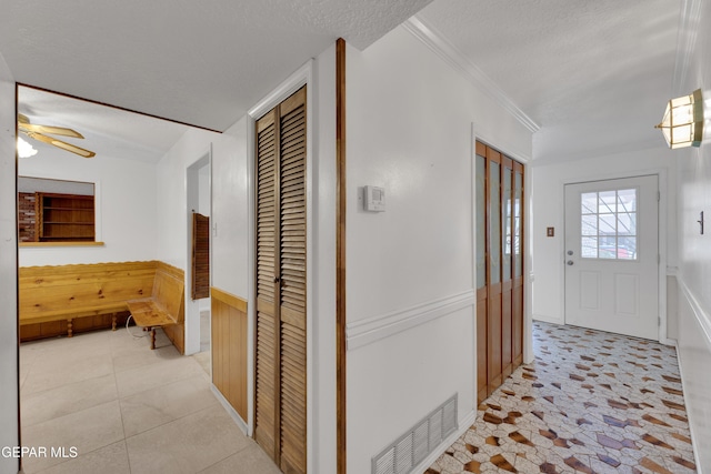 3313 Dublin Rd, El Paso, TX 79925 - corridor with a wainscoted wall, a textured ceiling, wooden walls, and ornamental molding