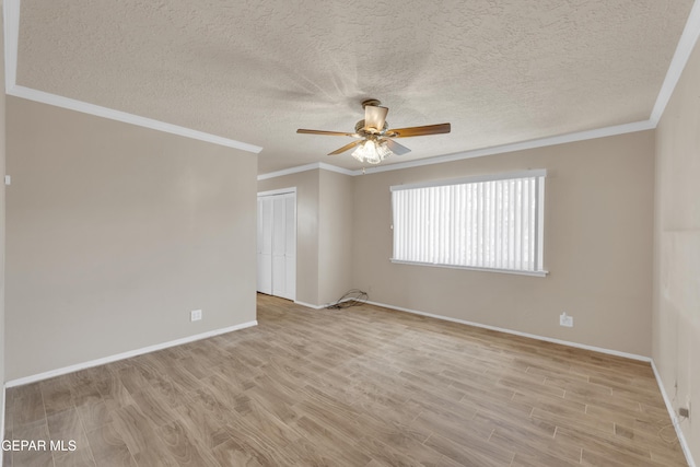 3313 Dublin Rd, El Paso, TX 79925 - spare room with a ceiling fan, light wood-style floors, ornamental molding, and a textured ceiling