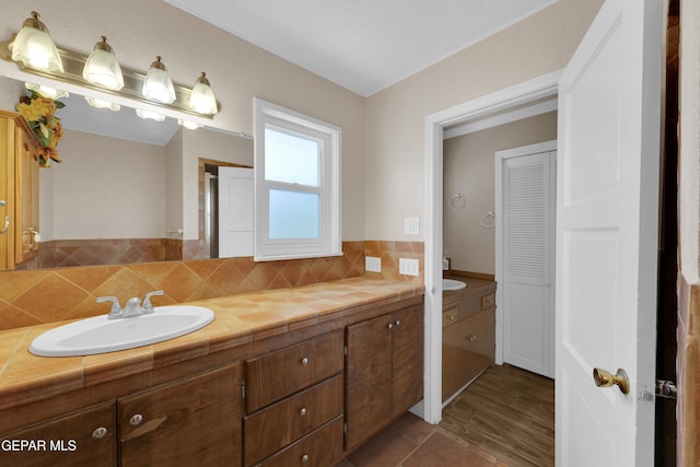 3313 Dublin Rd, El Paso, TX 79925 - bathroom with vanity and tasteful backsplash
