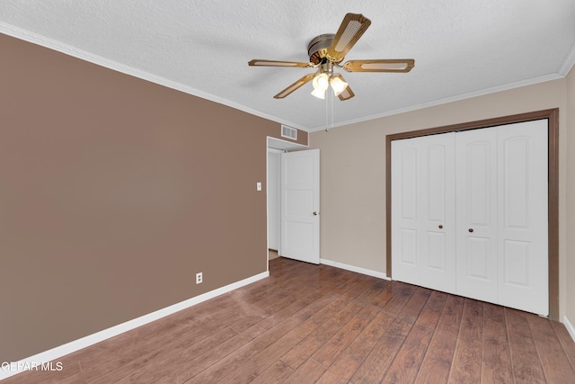 3313 Dublin Rd, El Paso, TX 79925 - unfurnished bedroom featuring wood finished floors, a textured ceiling, ornamental molding, a closet, and ceiling fan