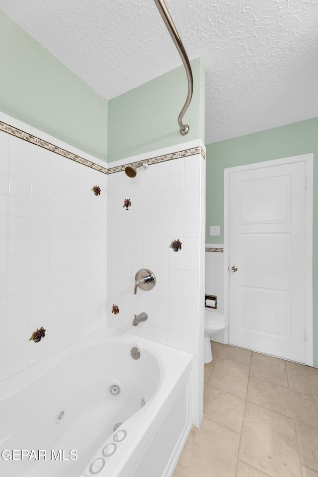 3313 Dublin Rd, El Paso, TX 79925 - full bathroom featuring a textured ceiling, tile patterned flooring, and a combined bath / shower with jetted tub