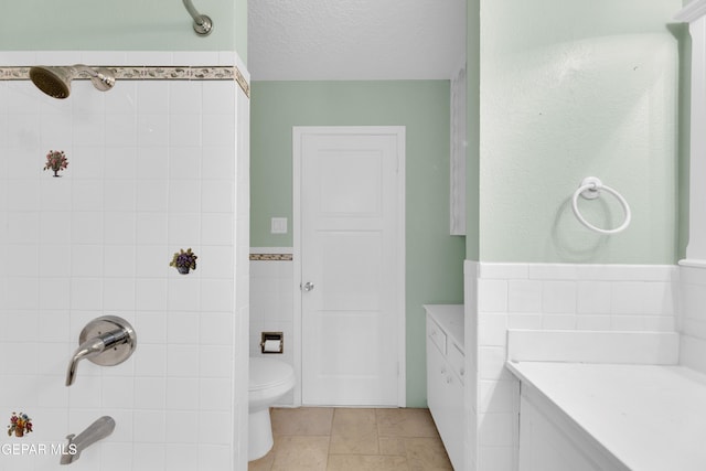 3313 Dublin Rd, El Paso, TX 79925 - bathroom with tile walls, vanity, a shower, wainscoting, and a textured ceiling