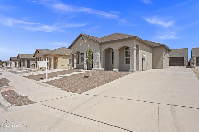 14373 Nick Drahos Ln, Horizon City, TX 79928 - mediterranean / spanish house featuring stucco siding, driveway, and a garage