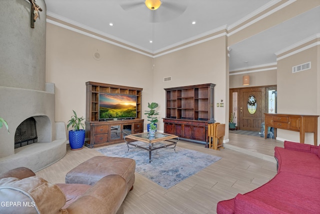 981 Vereda Del Valle Ave, El Paso, TX 79932 - living room featuring a ceiling fan, a high ceiling, a large fireplace, recessed lighting, and ornamental molding