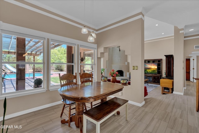 981 Vereda Del Valle Ave, El Paso, TX 79932 - dining room featuring ornamental molding, a tiled fireplace, and a towering ceiling