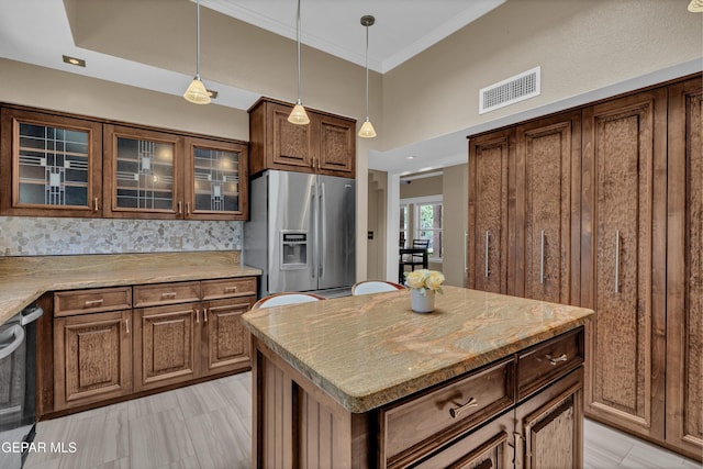 981 Vereda Del Valle Ave, El Paso, TX 79932 - kitchen with appliances with stainless steel finishes, glass insert cabinets, pendant lighting, tasteful backsplash, and crown molding