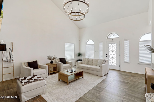 13847 Alamito Creek Ave, Clint, TX 79836 - living area with high vaulted ceiling, a chandelier, and wood finished floors