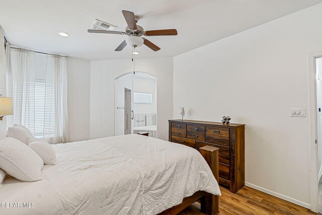 13847 Alamito Creek Ave, Clint, TX 79836 - bedroom with wood finished floors, arched walkways, recessed lighting, and ceiling fan