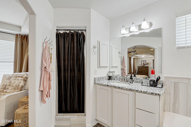 13847 Alamito Creek Ave, Clint, TX 79836 - bathroom featuring vanity, a ceiling fan, curtained shower, and connected bathroom