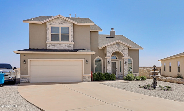13847 Alamito Creek Ave, Clint, TX 79836 - view of front of home with stone siding, an attached garage, and concrete driveway