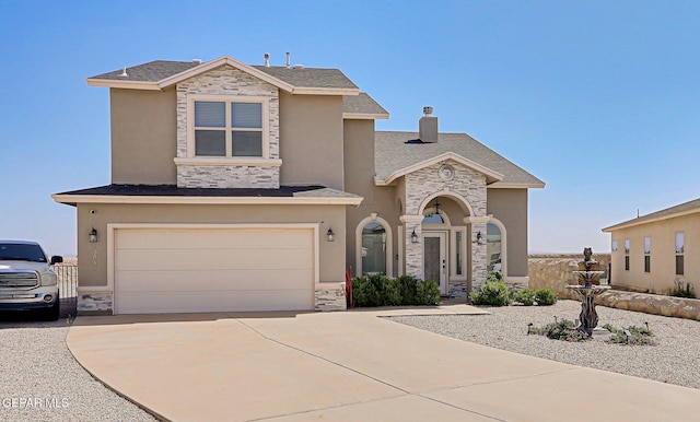 13847 Alamito Creek Ave, Clint, TX 79836 - view of front of home with stone siding, an attached garage, and driveway