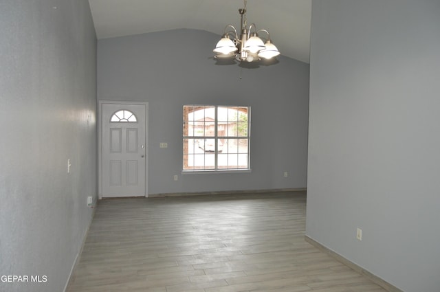 14309 Desierto Bueno Ave, Horizon City, TX 79928 - entryway featuring a chandelier, light wood finished floors, and high vaulted ceiling