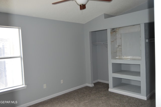 14309 Desierto Bueno Ave, Horizon City, TX 79928 - unfurnished bedroom featuring dark carpet, a closet, vaulted ceiling, and a ceiling fan