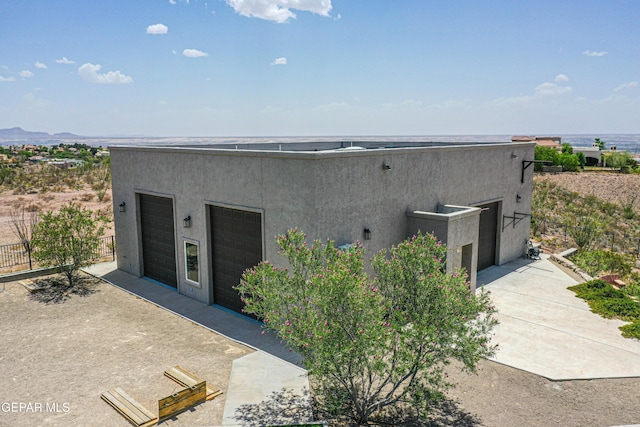 1348 Franklin Wind Place, El Paso, TX 79912 - view of exterior entry featuring stucco siding and a detached garage