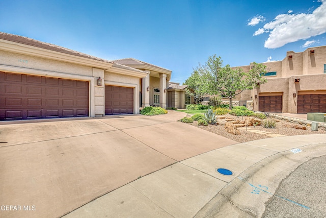 1348 Franklin Wind Place, El Paso, TX 79912 - view of front of house featuring concrete driveway, stucco siding, and an attached garage