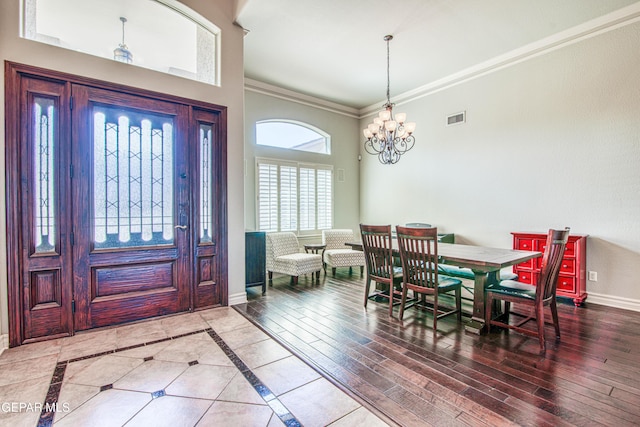 1348 Franklin Wind Place, El Paso, TX 79912 - foyer featuring crown molding, a chandelier, a towering ceiling, and wood finished floors