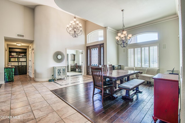 1348 Franklin Wind Place, El Paso, TX 79912 - dining space with a chandelier, healthy amount of natural light, a high ceiling, and crown molding