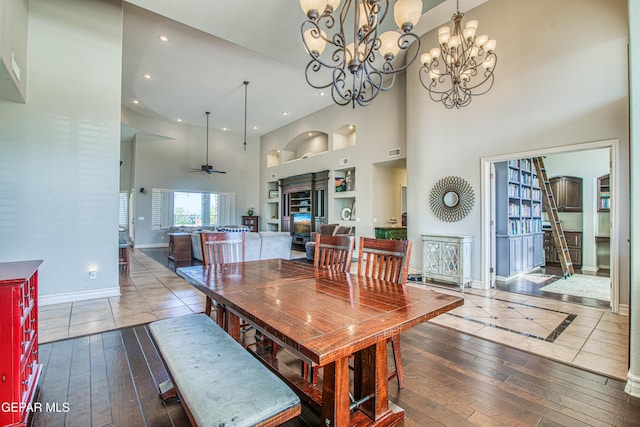 1348 Franklin Wind Place, El Paso, TX 79912 - dining space with a towering ceiling, built in features, wood-type flooring, a chandelier, and recessed lighting