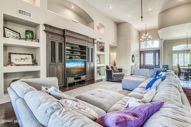 1348 Franklin Wind Place, El Paso, TX 79912 - living room featuring a chandelier, built in features, a high ceiling, dark wood-style flooring, and recessed lighting