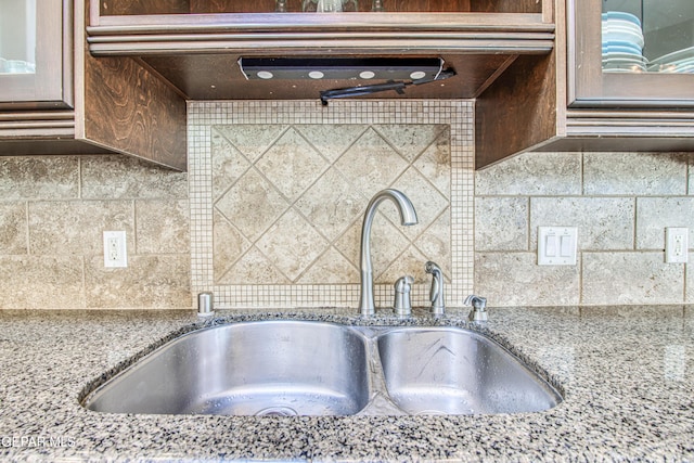 1348 Franklin Wind Place, El Paso, TX 79912 - kitchen view of tasteful backsplash, light stone countertops, glass insert cabinets, and exhaust hood