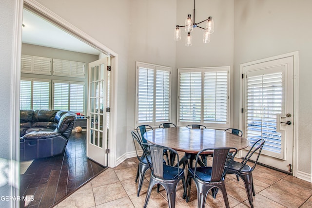 1348 Franklin Wind Place, El Paso, TX 79912 - tiled dining space featuring a chandelier and a towering ceiling