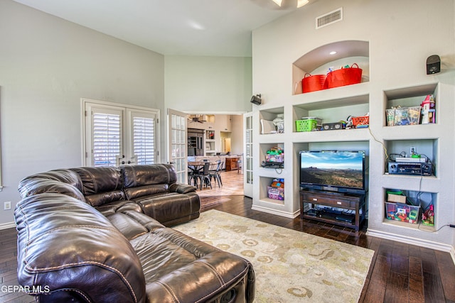 1348 Franklin Wind Place, El Paso, TX 79912 - living area featuring dark wood finished floors, built in features, french doors, a towering ceiling, and a ceiling fan
