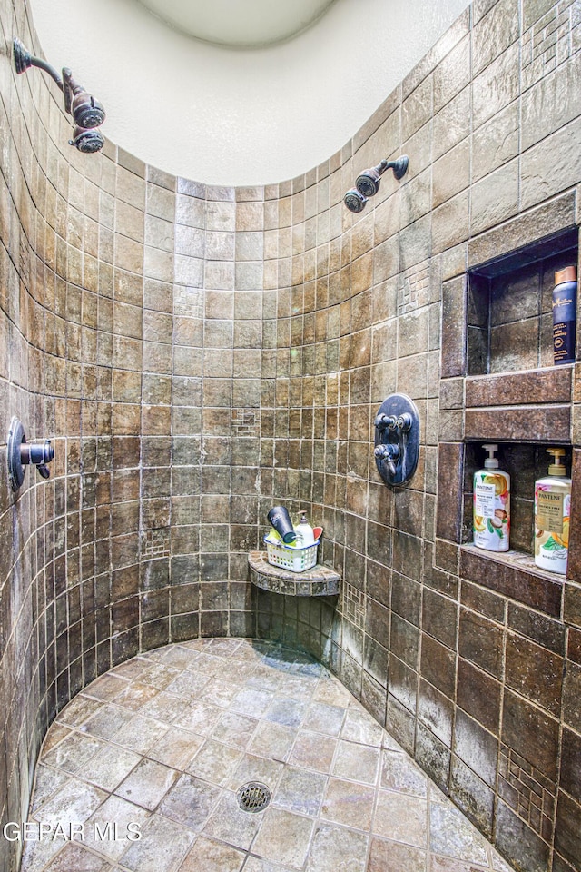 1348 Franklin Wind Place, El Paso, TX 79912 - bathroom with tiled shower and stone finish floors