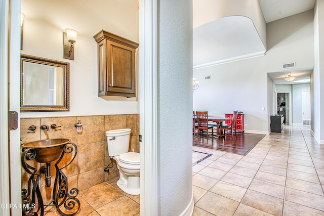 1348 Franklin Wind Place, El Paso, TX 79912 - bathroom with tile patterned flooring, tile walls, and a wainscoted wall