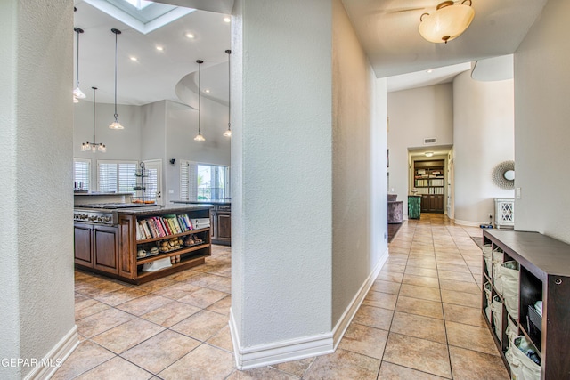 1348 Franklin Wind Place, El Paso, TX 79912 - corridor with a towering ceiling, a textured wall, light tile patterned floors, a skylight, and recessed lighting