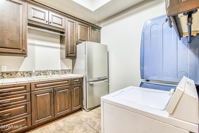 1348 Franklin Wind Place, El Paso, TX 79912 - washroom with washing machine and dryer and light tile patterned floors