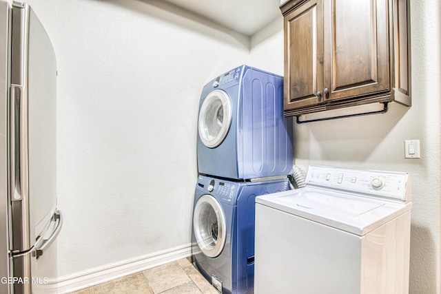 1348 Franklin Wind Place, El Paso, TX 79912 - washroom with cabinet space, estacked washer and dryer, and a textured wall